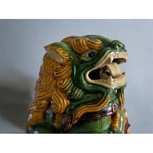 92 - A Chinese Sancai glazed Fo dog.Height - 35cmWidth - 30cm