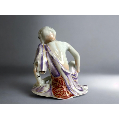 127 - A Chinese porcelain figure of Lohan.Qing dynasty.Hand painted.Height - 11cm