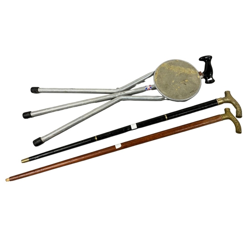 493 - Collection of Walking Sticks, Tirion Tripod Shooting Seat, and 2 Brass Handled examples one Collapsi... 