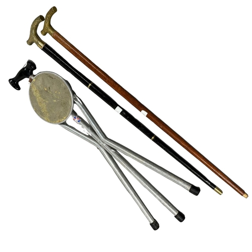 493 - Collection of Walking Sticks, Tirion Tripod Shooting Seat, and 2 Brass Handled examples one Collapsi... 