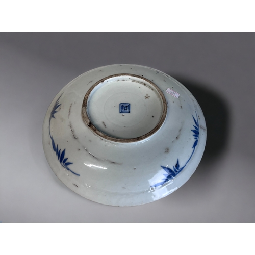 220 - A CHINESE PORCELAIN BLUE & WHITE DISH. Qing dynasty. Painted with a Phoenix and large blossoming... 