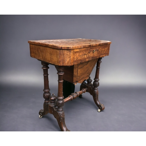 573 - A VICTORIAN BURR WALNUT WORK TABLE. Carved legs raised on original casters. Joined by turned wood st... 