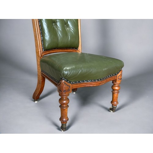 575 - A Victorian carved Walnut & leather button back occasion. Raised on four casters.