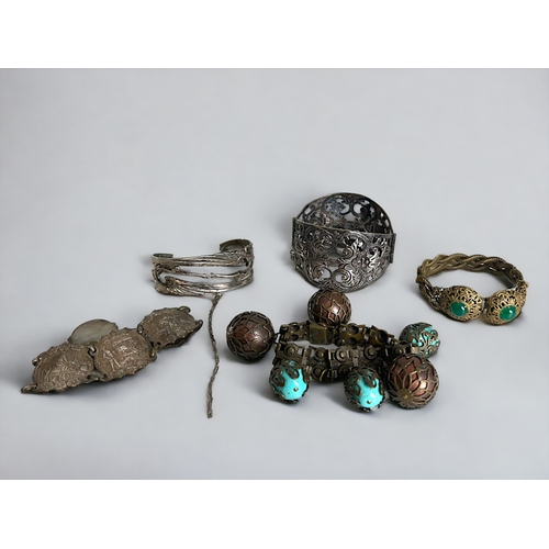 581 - A collection of five vintage bracelets. Including a French scrolled souvenir cuff bracelet, an Art N... 