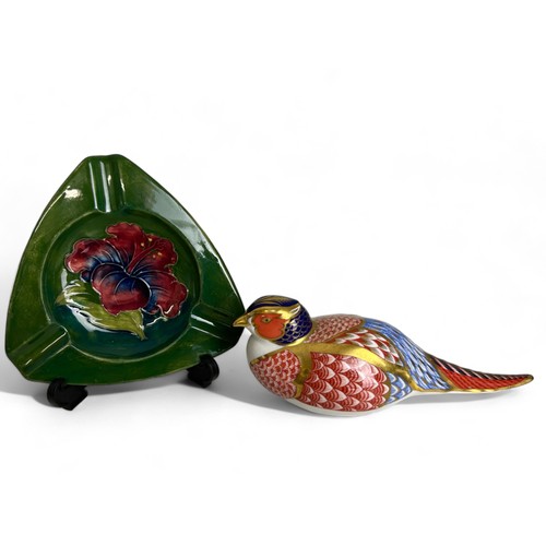 593 - A Moorcroft 'Hibiscus' patternash tray, together with a Royal Crown Deby Pheasant paperweight.