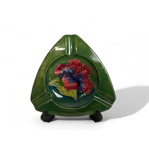 593 - A Moorcroft 'Hibiscus' patternash tray, together with a Royal Crown Deby Pheasant paperweight.