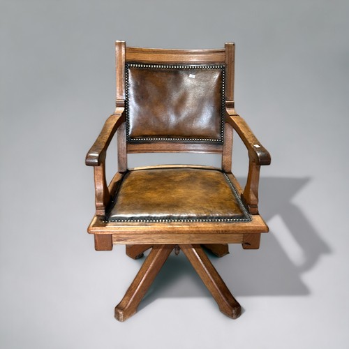 603 - An Arts & Crafts Oak Captains’ leather swivel chair.Width - 60cmDepth - 45cmHeight - 92cm... 