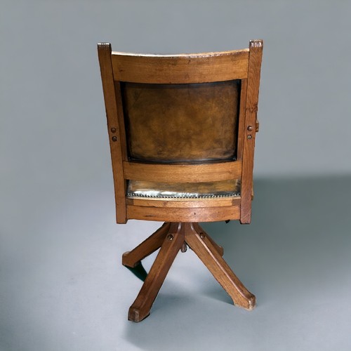 603 - An Arts & Crafts Oak Captains’ leather swivel chair.Width - 60cmDepth - 45cmHeight - 92cm... 