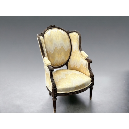 612 - A Louis XVI upholstered carved walnut Bergère armchair.French, 19th century.Height - 107cm... 