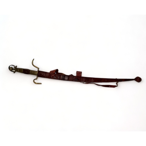 629 - A Taureg / Berber carved sword & Scabbard.
North Africa, 20th century.
Length - 110cm