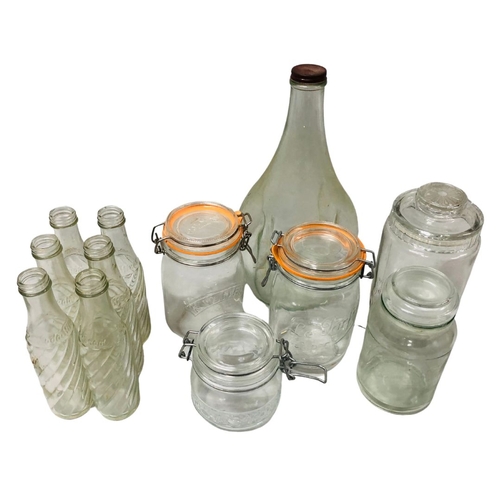 697 - Vintage and later glassware to include bottles and storage jars.