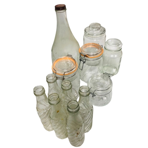 697 - Vintage and later glassware to include bottles and storage jars.