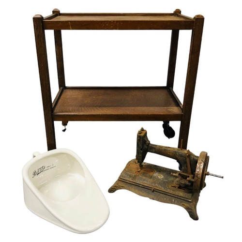 699 - An Antique Porcelain Slipper Bed Pan with an Antique well worn sewing machine and a Hostess Trolley