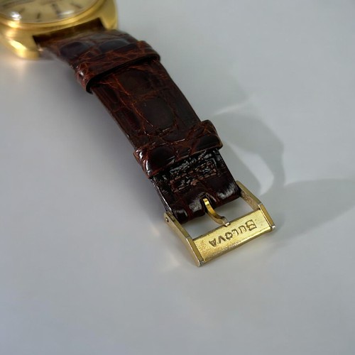 470 - 18ct gold Bulova Accutron wristwatch.Circular gilt dial with day & date aperture. Cushion shape ... 