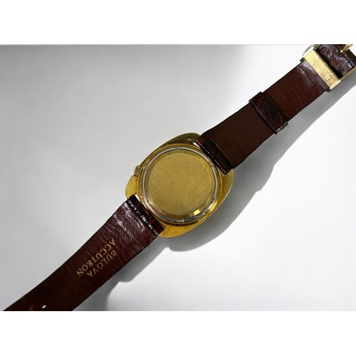 470 - 18ct gold Bulova Accutron wristwatch.Circular gilt dial with day & date aperture. Cushion shape ... 