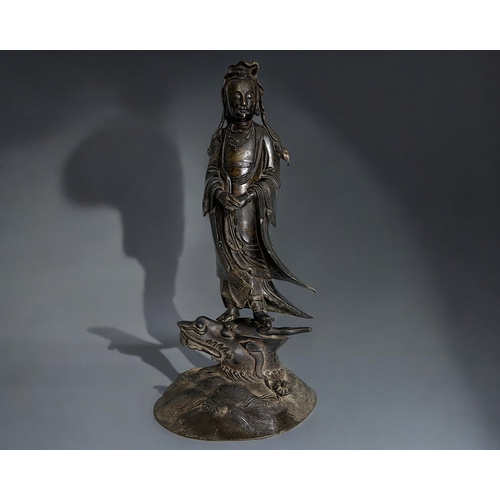 11 - A large bronze figure of Guanyin.Chinese, Qing dynasty. Standing, with crossed hands pose with long ... 