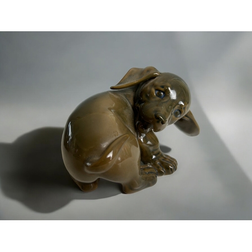 53 - A pair of Royal Copenhagen Dachshund puppies.Including early model 1407, together with a model 1408.... 