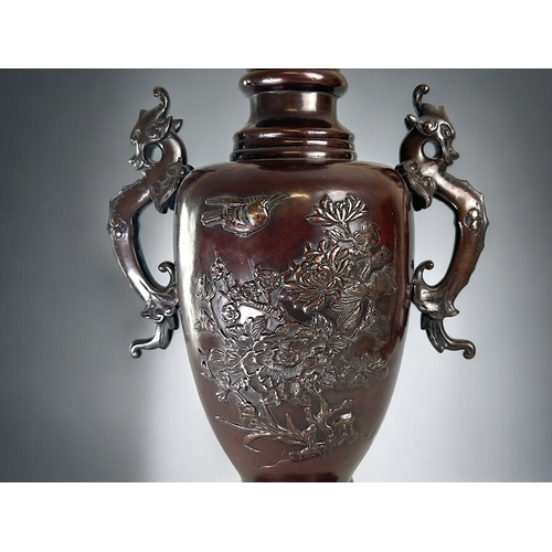 12 - A large Bronze twin handle vase.Japanese, Meiji period (19th century).Relief decorated with birds an... 