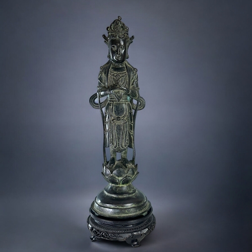 13 - A large Chinese Bronze figure of Guanyin.Qing dynasty.Robed Guanyin standing on tiered lotus base. D... 