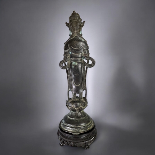 13 - A large Chinese Bronze figure of Guanyin.Qing dynasty.Robed Guanyin standing on tiered lotus base. D... 