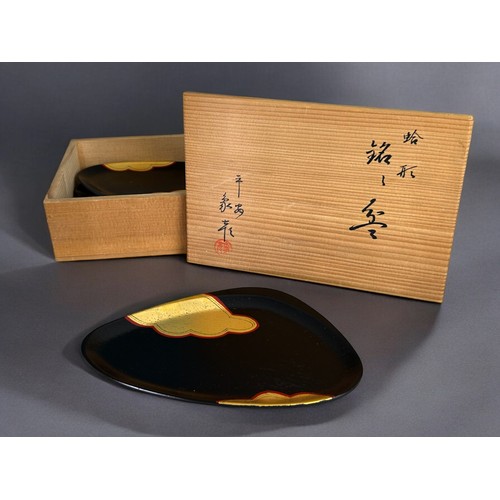 146 - A boxed Japanese pottery Sake set.Together with a boxed set of lacquer serving dishes.