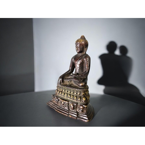 16 - A Tibetan bronze Buddha figure.Seated in vajrasana, sat on double lotus base. In the Pala style. Hei... 