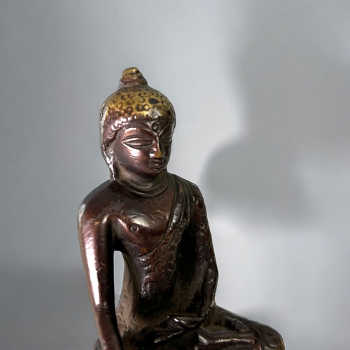 16 - A Tibetan bronze Buddha figure.Seated in vajrasana, sat on double lotus base. In the Pala style. Hei... 