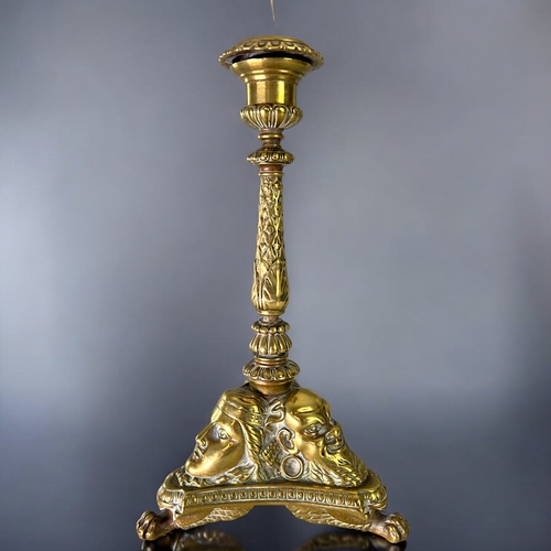 435 - A Grand Tour gilt bronze candlestick.France, 19th century.Sat on three winged Lion paw feet, with st... 