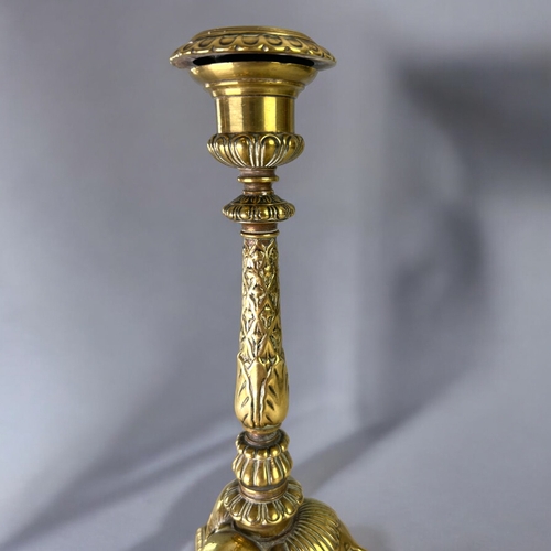 435 - A Grand Tour gilt bronze candlestick.France, 19th century.Sat on three winged Lion paw feet, with st... 