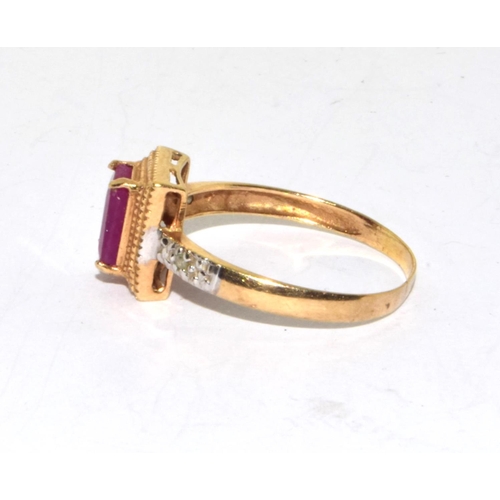 553 - 9ct gold ladies Ruby and Diamond Halo ring size O