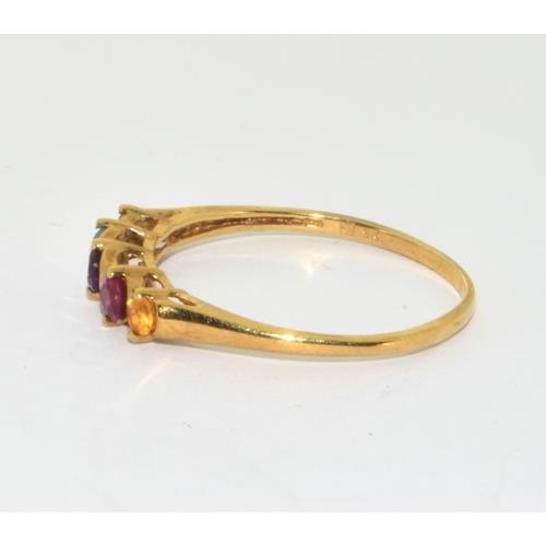 561 - 9ct gold ladies semi precious stone ring set with Ruby, Amber , Garnet Aquamarine, and Tourmaline si... 