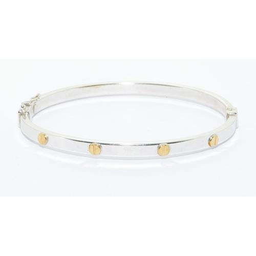 563 - 9ct white gold solid bangle in a cartier love bangle design hinged spring clip closing 7.0g