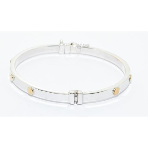 563 - 9ct white gold solid bangle in a cartier love bangle design hinged spring clip closing 7.0g