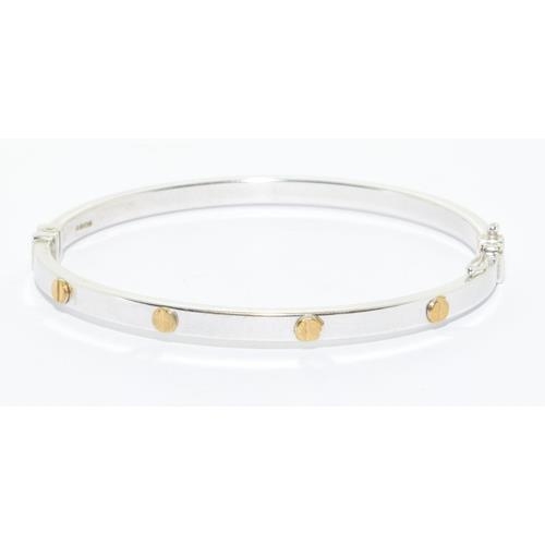 563 - 9ct white gold solid bangle in a cartier love bangle design hinged spring clip closing 7.0g