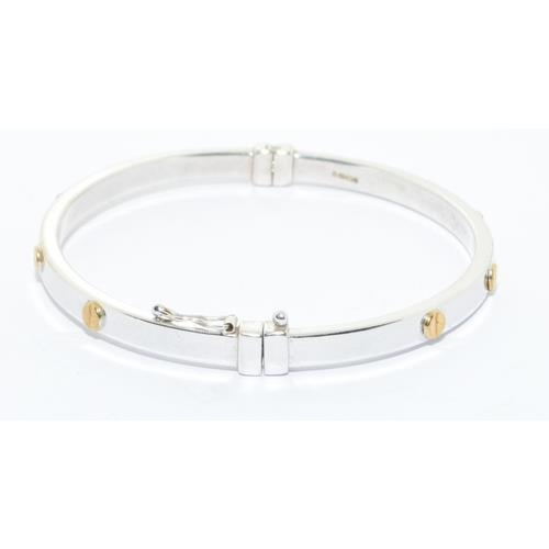 563 - 9ct white gold solid bangle in a cartier love bangle design hinged spring clip closing 7.0g