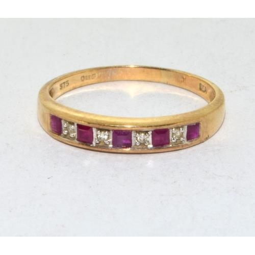 565 - 9ct gold ladies Diamond and Ruby 1/2 eternity ring in a channel setting size Q