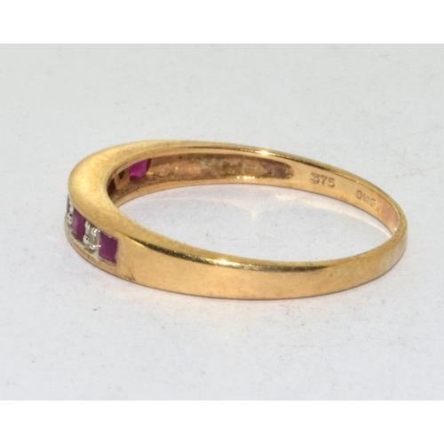 565 - 9ct gold ladies Diamond and Ruby 1/2 eternity ring in a channel setting size Q