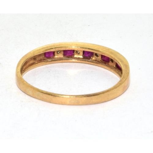 565 - 9ct gold ladies Diamond and Ruby 1/2 eternity ring in a channel setting size Q