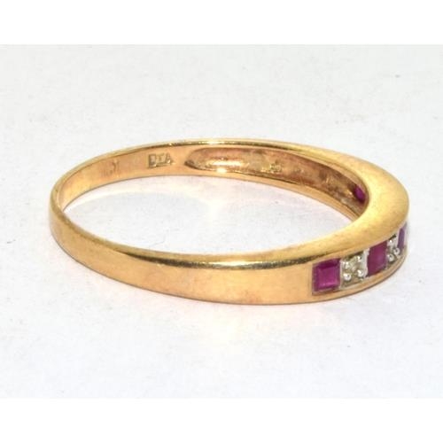 565 - 9ct gold ladies Diamond and Ruby 1/2 eternity ring in a channel setting size Q