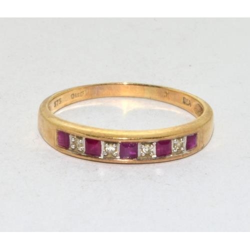 565 - 9ct gold ladies Diamond and Ruby 1/2 eternity ring in a channel setting size Q