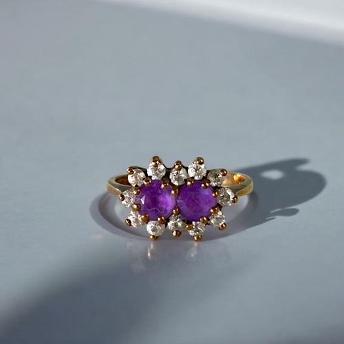 482 - A 9ct Gold & Amethyst set ladies ring.Two round cut Amethyst, surrounded with clear stones. Hall... 