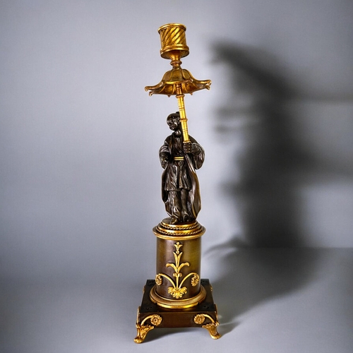 436 - A Charles X Gilt and Patinated bronze Chinoiserie candlestick.French, 1st quarter 19th century.Heigh... 