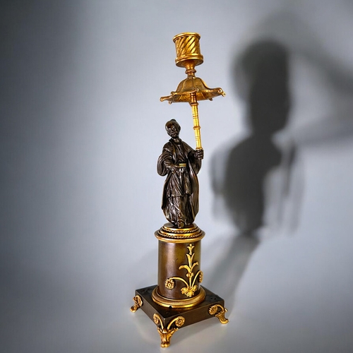 436 - A Charles X Gilt and Patinated bronze Chinoiserie candlestick.French, 1st quarter 19th century.Heigh... 