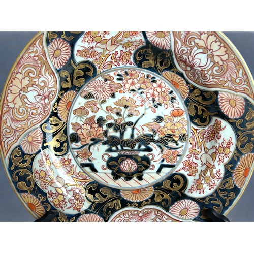 24 - A Japanese 'Imari' porcelain charger.Meiji period, 19th century.Centrally painted vase of blossoming... 