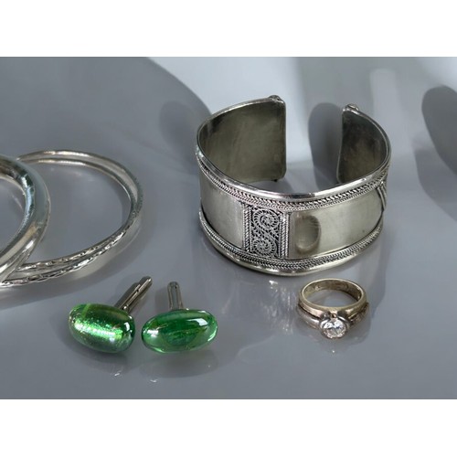 603 - A collection of ladies jewellery. To include white metal bangles, silver Neillo Siam cufflinks, earr... 