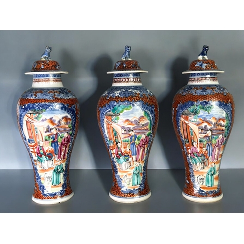 32 - A garniture of three Chinese export porcelain Mandarin vases.Qing dynasty, 18th century.Baluster for... 