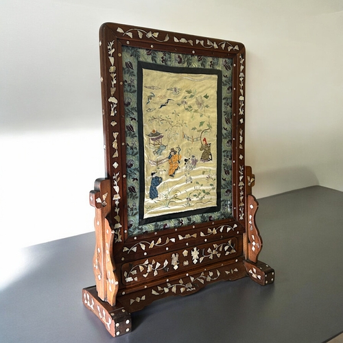 45 - A large Chinese Rosewood & mother-of-pearl inlaid screen.Fitted with Chinese silk embroidered pa... 