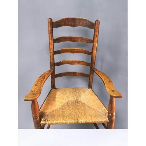 27 - Mid 19th Century Oak and Rush Seated Ladder Back Arm/Reading Chair. Nice dimensions and lovely Patin... 