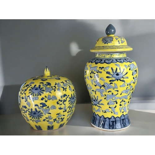 97 - Two large Chinese yellow ground porcelain vases.Painted with blossoming Peonies. One Baluster form a... 