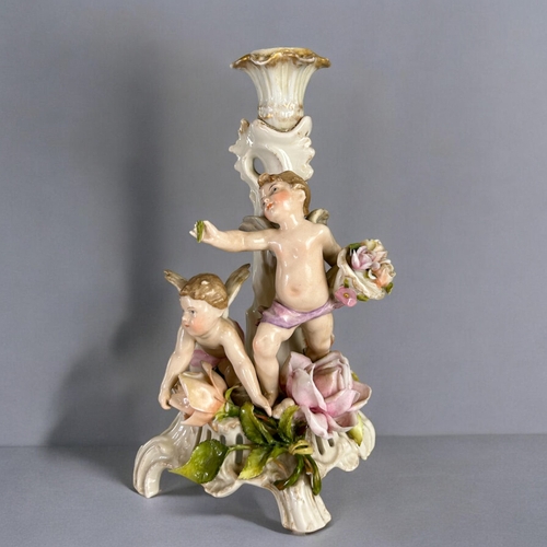 138 - A late 19th century German Plaue porcelain comport / candlestick.Depicting a pair of cherubs amongst... 